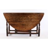 18th Century oak drop leaf table, with a circular drop leaf top above turned legs united by
