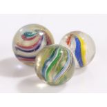 Collection of three 19th Century glass marbles, to include Latticinio core swirl and two solid