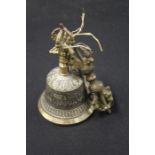 Cast brass bell, with mask and scroll decoration, cast brass rest, with pierced scroll decoration (