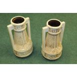Pair of Bretby Art Pottery twin handled vases, relief decorations on a cream coloured ground, marked