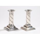 Pair of silver plated dwarf candlesticks, with beaded detachable sconces, the stems with cast oak