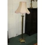 Brass corinthian column standard lamp, raised on a square plinth base and paw feet