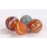 Collection of four 19th Century glass marbles, to include onion skin examples, size range 13mm to