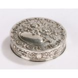 Continental silver box, of circular form, the hinged lid embossed with flowers and with vacant