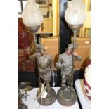Pair of Spelter lamps, in the form of cavillers holding torches with flame style glass shades
