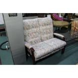Cottage style two seat settee, with foliate decoration and show wood frame
