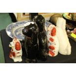 Staffordshire and Staffordshire style pottery spaniels, to include a pair in black, a single white