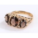 9 carat gold smoky quartz ring, with three quartz stones and clear paste set to the head, ring