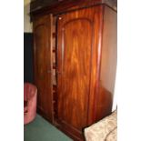 Victorian mahogany wardrobe, of tall proportions, the concave cornice above a pair of double doors