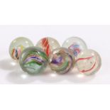 Collection of six 19th Century glass marbles, to include Latticinio core swirls and solid, size
