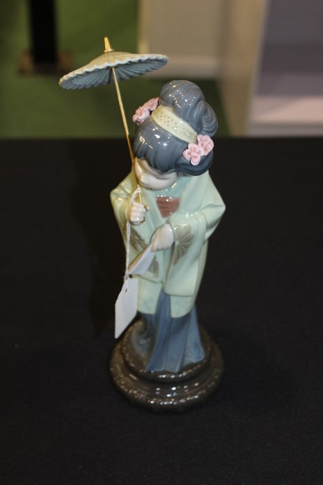 Lladro porcelain figure depicting a geisha holding a parasol, 30cm high