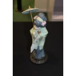 Lladro porcelain figure depicting a geisha holding a parasol, 30cm high