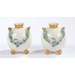 Pair of Royal Worcester spherical vases, the twin-handled bodies with floral relief decorations on a