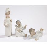 Three Lladro figures, depicting two angels, one playing the lute and one lying down, and a girl