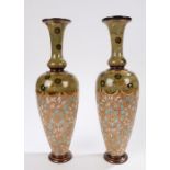 Pair of Doulton Lambeth stoneware vases, of ovoid form with a flared neck, decorated with a textured