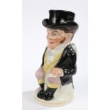 Toby Jug in the form of a man seated resting his arm on his lap, marked RN153478 to the base, 25cm