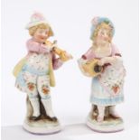 Pair of Continental porcelain figures, depicting a boy and a girl playing with instruments, 17cm