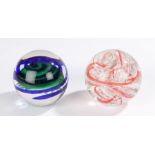 Two Langham glass paperweights, decorated with various colours and bubble inclusions, marked to