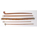 A collection of five Naval and Military related walking sticks to include, an oak walking stick with