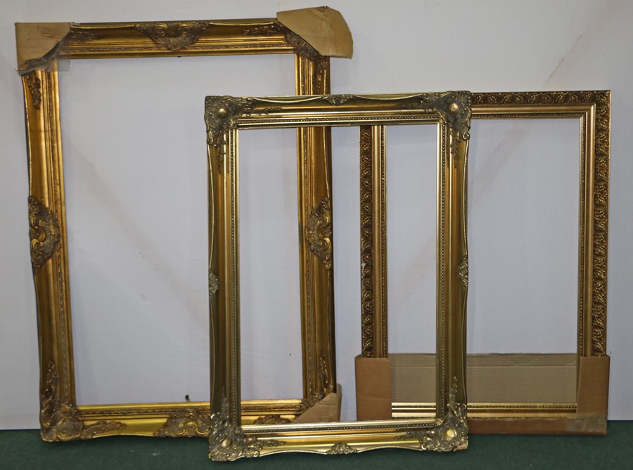 Three large gilt picture frames, the largest 77cm x 109cm, (3)