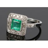 Emerald and diamond set ring, the central emerald at 0.85 carat with a diamond surround set on