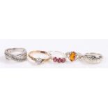 Five silver and coloured paste set rings, various sizes and styles, to include an amber set example,