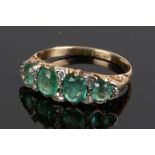 Emerald and diamond set ring, with four emeralds and eight diamond divides, estimated total