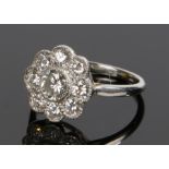 Diamond set flower head ring, with nine diamonds to the head forming a flower, estimated diamond