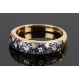 18 carat gold sapphire and diamond set ring, with rows of diamonds with sapphire surrounds,