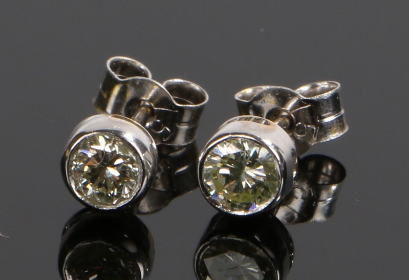 Pair of diamond set ear studs, with an estimated diamond weight of 0.30 carat