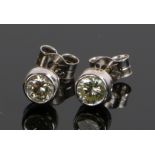 Pair of diamond set ear studs, with an estimated diamond weight of 0.30 carat