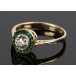 Diamond and emerald ring, the central diamond at an estimated 0.50 carat and a emerald surround,