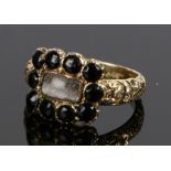 George III Mourning ring, the central glass head with a fabric panel and black bead surround, the