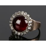Garnet and diamond set ring, with cabochon cut garnet with a diamond surround, ring size M 1/2