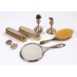 Silver vanity set, with a mirror and three brushes, together with two damaged candlesticks