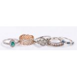 Five silver and coloured paste set rings, various sizes and styles, to include a pierced foliate