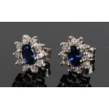 Pair of diamond and sapphire set ear studs, with a central sapphire and diamond surround to each,