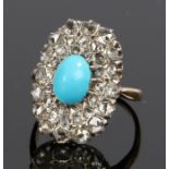 Turquoise and diamond set ring, the central cabochon turquoise with a dual diamond surround, ring
