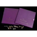 Royal Mint, two cased United Kingdom Crowns, together with a collection of buttons and tie clips, (