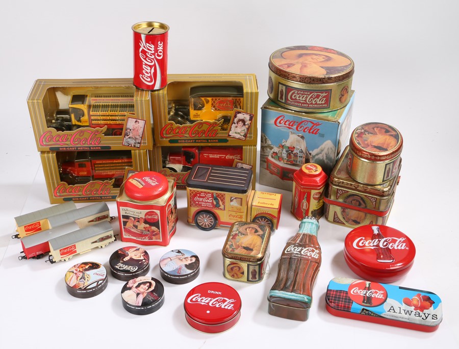 Coca-Cola interest, a collection of tins and die-cast metal banks, four model train carriages, and