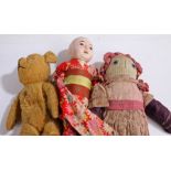 Early teddy bear, together with an Oriental figure doll, a folk art doll and another, (4)
