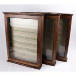 Three glazed model display cabinets, hinged doors opening to reveal seven glass shelves, 65cm x 48cm