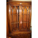 Yew wood veneered astragal glazed corner cabinet of inverted both front form