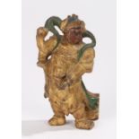 Eastern carved figure, with a red face and green bands to the gilt body, 11.5cm high