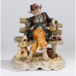 Capodimonte figure, depicting a man sitting on a bench, marked to the base, 25cm high