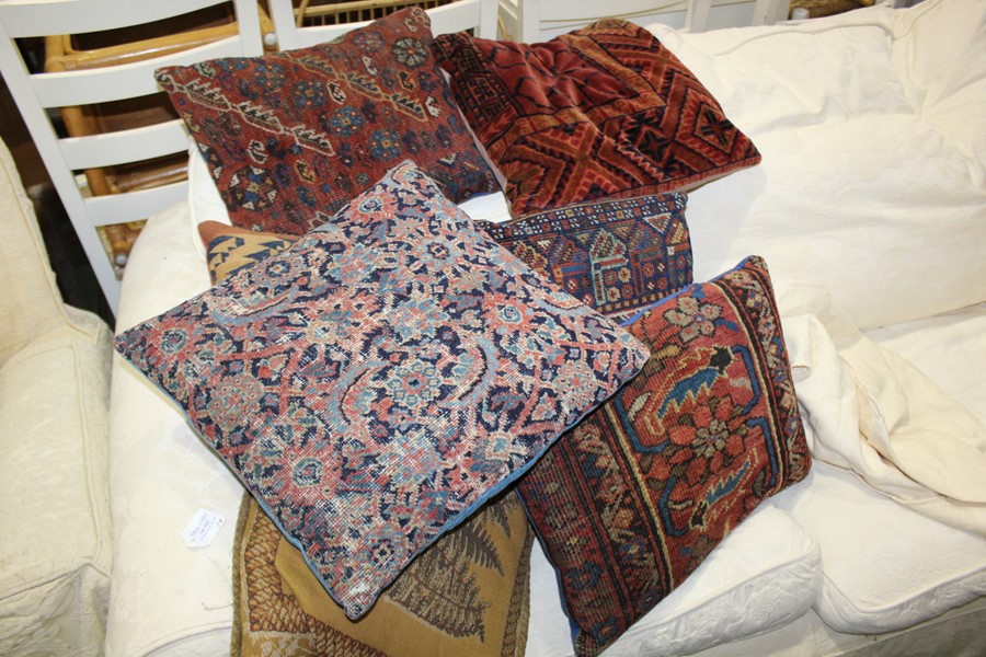 Seven cushions, to include six cushions made from Middle Eastern rugs and another cushion, (7)