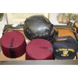 Miners helmet, together with two fez's a USS Theodore Roosevelt cap, together with three books