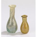 Two Roman 3rd Century bottles, with wide rims and bulbous bodies, 45mm and 70mm high, (2)