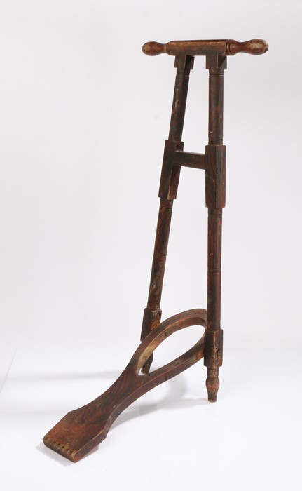 Victorian boot jack, with turned handle above the folding boot jack