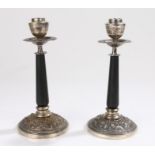 Pair of Indian silver candlesticks, with a sconce above the tapering column and foliate base, 21cm